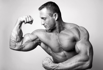 Muscular man flexing his biceps - studio shot